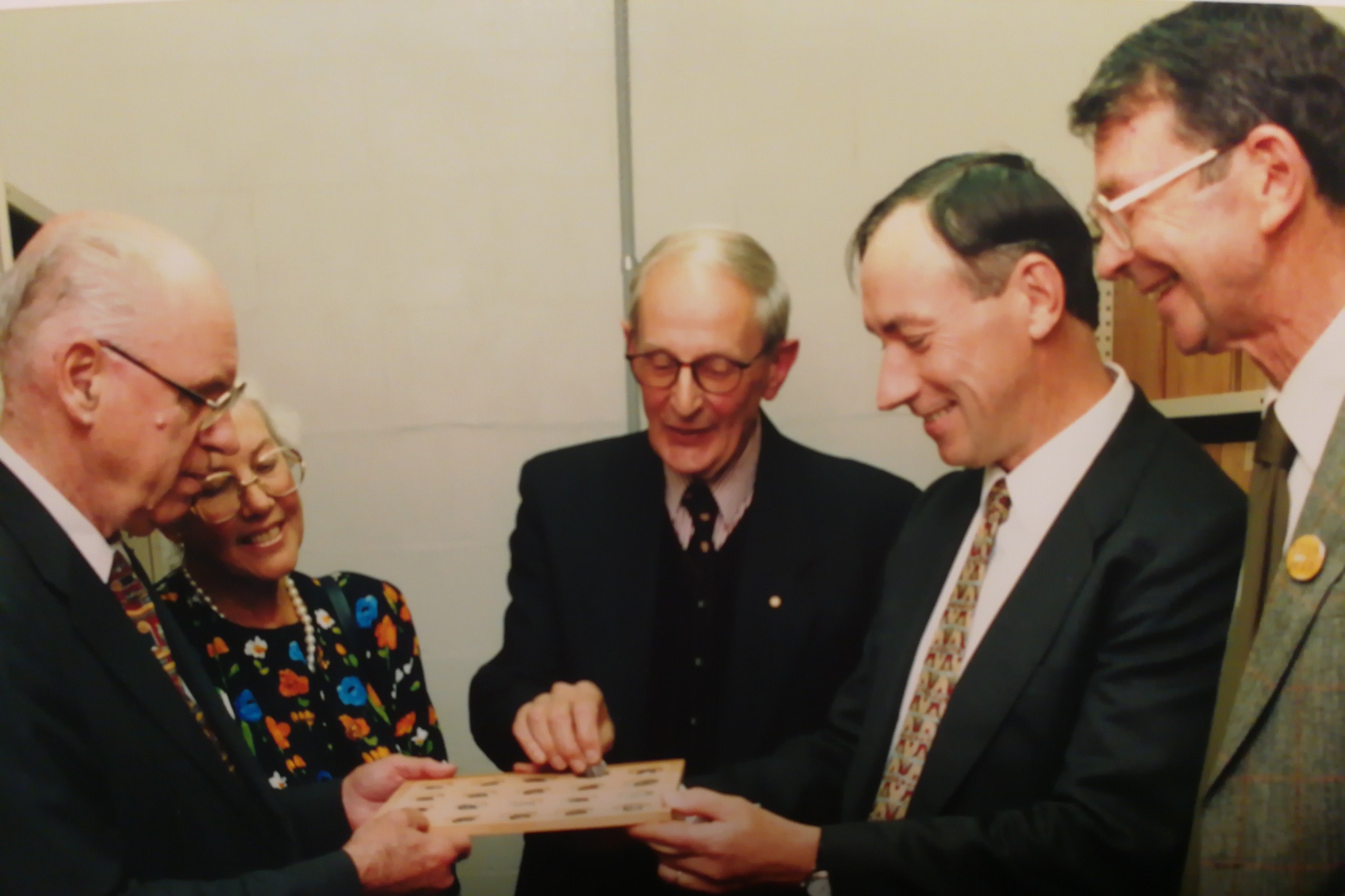 Dr W. L. Gale. Mrs Janet Gale, Professor Edwin Judge, A/Prof Kenneth Sheedy, and A/Prof Ted Nixon standing around a coin tray
