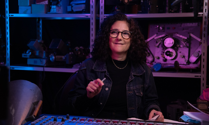 Image of woman in a control room with audio panels