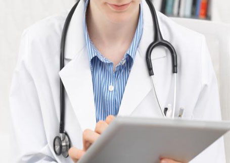 A doctor checking her notes on an iPad
