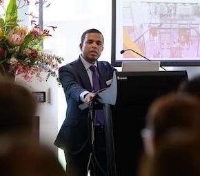 Professor Aman Oo stands at lectern addressing industry expo