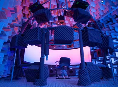 Digital art showing a chair and a large monitor surrounded by speakers.
