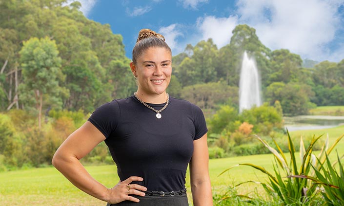 Piper standing in front of Macquarie University lake