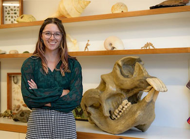 Photo of Sally Hurst with fossils in background