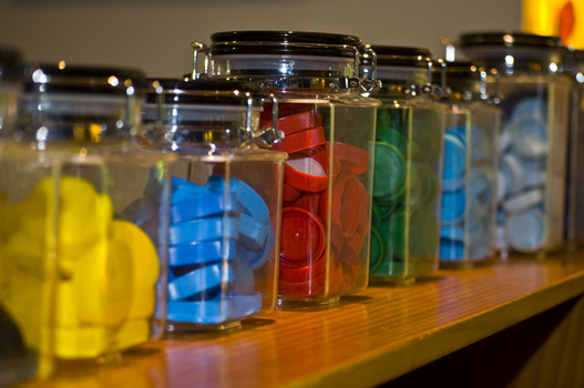 Coloured items in glass jars
