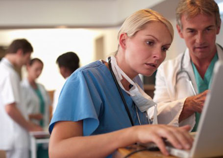 A doctor and nurse looking at a computer