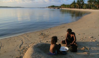 image of mother and child sitting on the beach