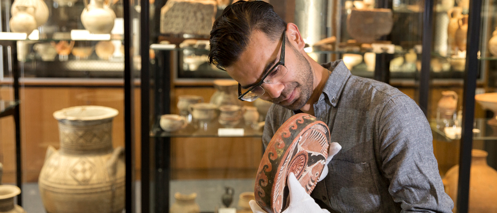 Researcher with ancient pottery