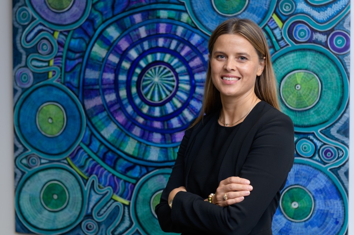 Professor Catherine McMahon in front of Belanjee painting