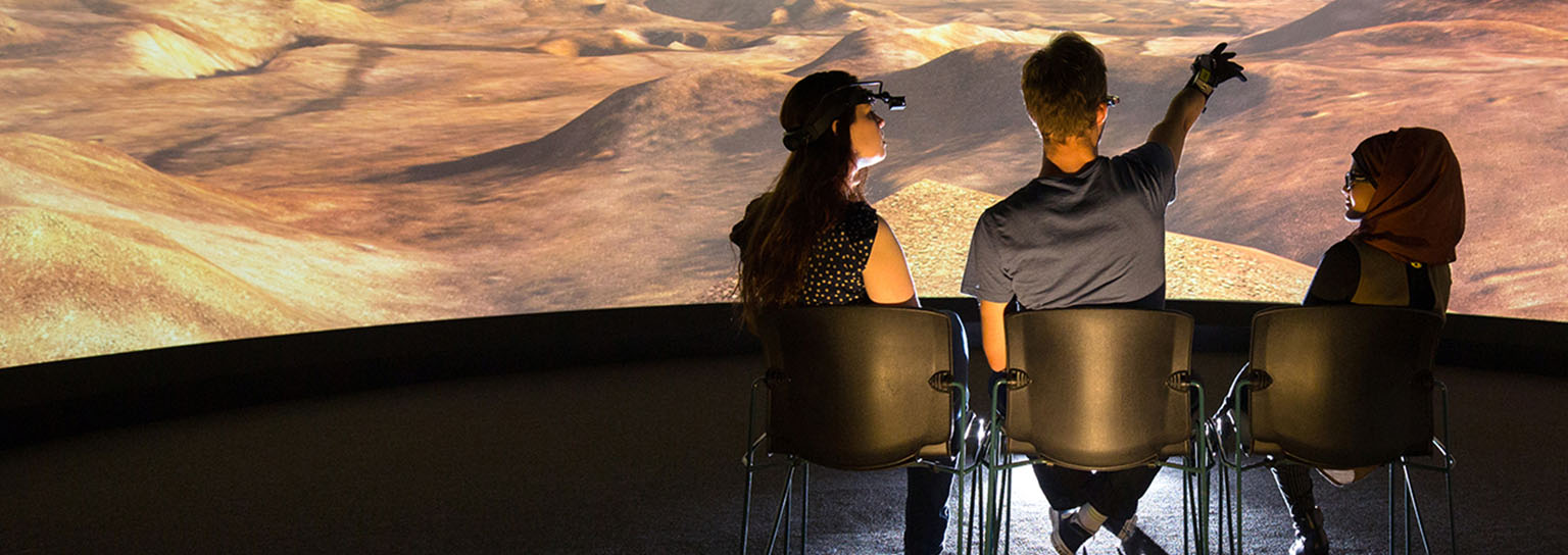 Three people observing virtual reality screen