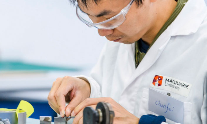 Dr Chunfei Chen in lab coat conducting experiment