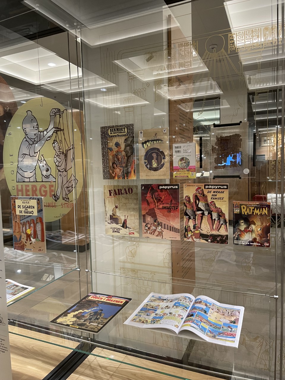 Photograph of museum display case containing comic books about Ancient Egypt