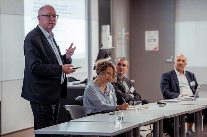 Three-people-presenting-at-event