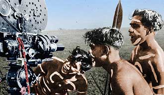 Two Indigenous boys with a movie camera