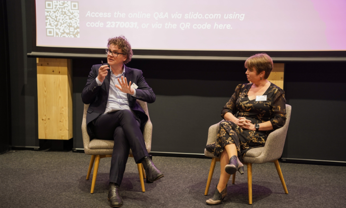 Image of a man and woman hosting a panel discussion