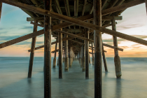 Pylons at the beach. Photo by Scott Trento on Unsplash