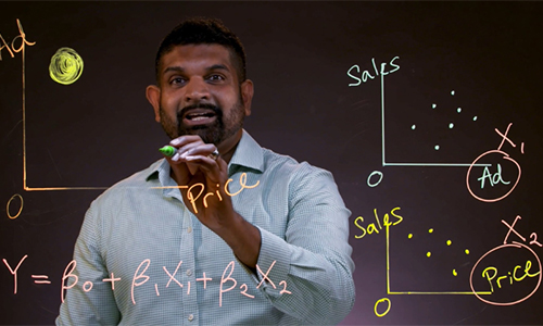 Prashan Karunaratne doing maths on a transparent screen with texters