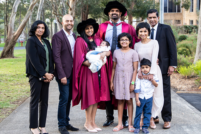 Prashan Karunaratne and his wife graduating and taking a group photo with their families