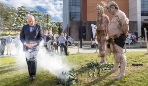 Professor S Bruce Dowton walking through the smoke before turning the sod. Photo: Paul Wright Photography